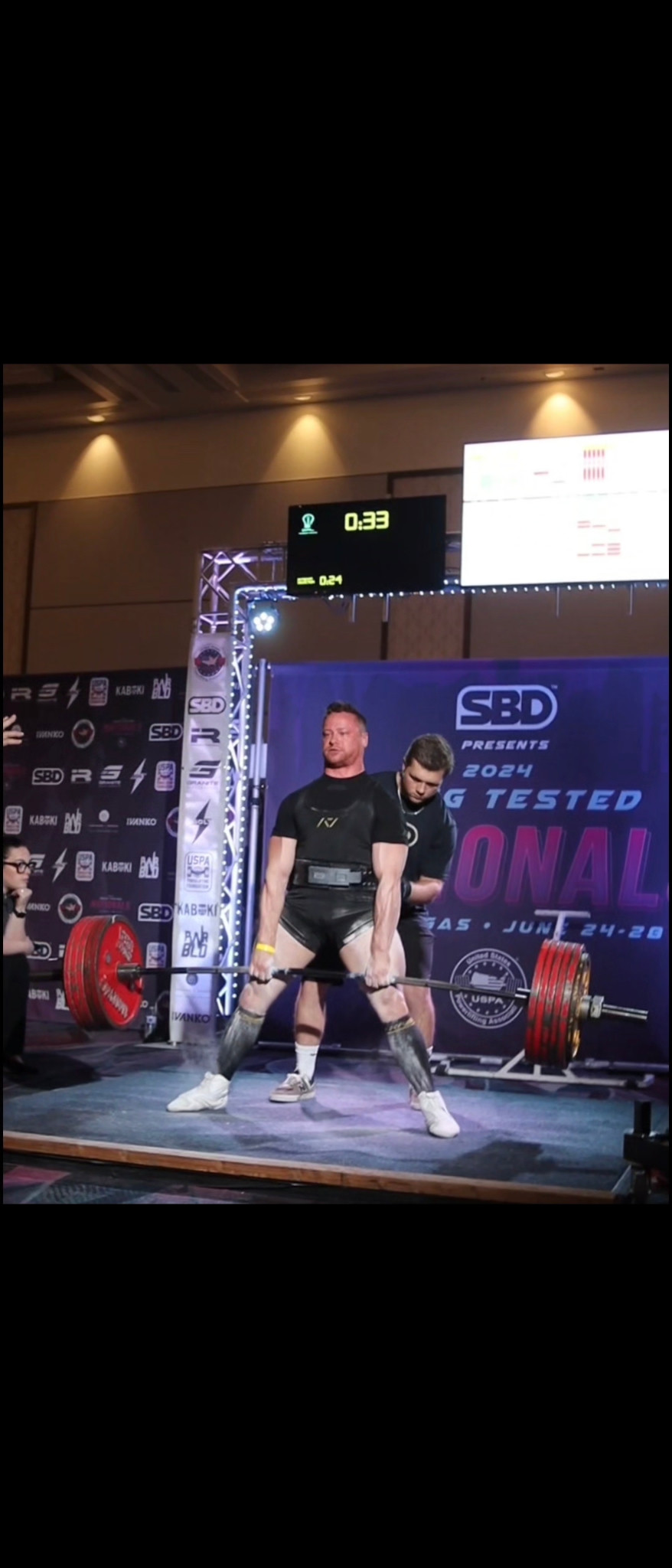 Daniel deadlifting on a competition platform.